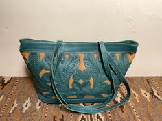 Leaders In Leather, Rare Find Old Stash,New, Never Used, Tag Still On. Beautifully Cutout, Tooled Shoulder Bag, Excellent quality, and Classic, Boho Chic Western Color: Turquoise/Beige, Bold and chic, accents the wardrobe with style Eye catching, definitely one of my, on-the-go bags, This Bag has much Style and Lots of room. Check out the photos for a visual description. I love a wide top for a bag, Easy to find things. Shoulder Bag Straps length 14 1/2"  Shoulder Bag inside small side pocket w/Zipper Shoulder Bag Top Zipper 16"  Shoulder Bag height 11" Bag Bottom width 7" Bag Bottom Length 14" Inside Lined with Beautiful Signature Gold and Black Fabric, Credit Card Slots, and a Pen Slot. Box # 7 About: Leaders In Leather, LEADERS IN LEATHER was founded in 1993 in Austin, Texas by Chilean- Turquoise Hand Tooled Shoulder Bag For Everyday Use, Hand Tooled Turquoise Shoulder Bag For Everyday Use, Turquoise Hand Tooled Rectangular Shoulder Bag, Turquoise Hand Tooled Bags For Everyday Use, Hand Tooled Turquoise Bag For Everyday Use, Turquoise Hand Tooled Travel Bag, Turquoise Hand Tooled Everyday Bags, Turquoise Hand Tooled Shoulder Bag For Travel, Green Hand Tooled Bag For Daily Use