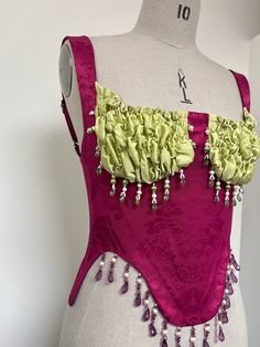 Made-to-order & historically inspired scalloped bustier. Corseted bodice in berry brocade, boned with a mixture of polyester and steel boning.  Pistacio green silk satin cups, ruched with elastic for a stretchy and snug fit.  Embellished by hand around the cups and hem with mixture freshwater pearls and colourful beading.  Lace up back fastened with satin ribbon. Adjustable straps with sliders. I would recommend sending me your measurements (last photo) so your piece can be bespoke to your size. Corset Fairy, Vintage Bustier, Green Corset, Tomboy Chic, Corset Bustier, Corset Lingerie, Bustiers, Green Silk, Corsets