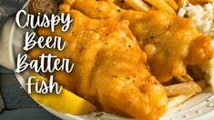 crispy beer battered fish on a plate with french fries and mashed potato wedges