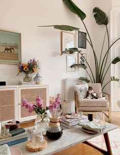 a living room filled with furniture and flowers