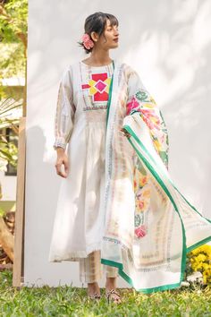 White anarkali featuring embroidered front yoke with Portuguese folk print on the back. Paired with a printed pant and a dupatta. - Aza Fashions Designer Cambric Anarkali Set With Printed Motifs, Designer Wear Cambric Anarkali Set With Printed Motifs, Anarkali Cotton Silk Kurta With Embroidered Border, Anarkali Dress With Embroidered Dupatta, Festive Cotton Silk Anarkali Set With Embroidered Border, Anarkali Lawn Suit With Embroidered Border For Wedding, Wedding Anarkali Lawn Suit With Embroidered Border, Anarkali Embroidered Chanderi Kurta, Anarkali Style Embroidered Chanderi Kurta