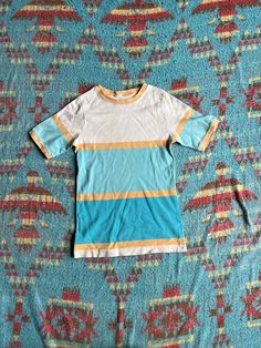 "This top has a simple and cheerful look to it. Great for everyday wear.  Fair shape. No tag. Bleach spot on one sleeve and two small spots along the bottom. Ca 1970s.  PTP: 14.5\" Length: 24\" If you have any questions, please send us a message. NGA *free shipping to lower 48 only" Retro Cotton Short Sleeve Tops, Retro Cotton Summer Tops, Retro Cotton Tops For Summer, Retro Fitted Cotton Tops, Fitted Retro Cotton Tops, Fitted Cotton Color Block Shirt, Fitted Cotton Shirt With Color Block, Vintage Multicolor Crew Neck Tops, Retro Cotton Tops With Relaxed Fit