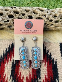 New without tags BRAND : Nizhoni Traders LLC ETHNIC & REGIONAL STYLE : Native American JEWELRY TYPE : Earrings METAL : Sterling Silver TRIBAL AFFILIATION : Navajo MAIN STONE : Turquoise Lovely Navajo Turquoise and Sterling Silver dangle earrings. Measure 2 7/8 inches long and 3/4 of an inch wide. Great pair of earrings! Stamped Sterling and signed by the artist. Thank you for checking out my store. Please contact me with any questions. Exported By exportyourstore.com Southwestern Style Blue Pierced Earrings, Southwestern Style Blue Earrings For Pierced Ears, Southwestern Blue Earrings For Pierced Ears, Southwestern Style Blue Drop Earrings, Southwestern Blue Drop Earrings, Southwestern Blue Earrings For Gift, Blue Southwestern Style Earrings For Gift, Navajo Turquoise, Earrings Metal