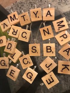 scrabbled letters are arranged in the shape of cubes on a chain