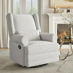 a living room with a rocking chair and fireplace