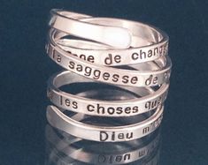 "Be inspired by this beautiful signature ring by donnaodesigns. A slender strip of sterling silver wraps around your finger with the comforting words of the Serenity Prayer: \"God grant me the serenity to accept the things I cannot change, courage to change the things I can and wisdom to know the difference.\" Want to add a date on the interior of the ring? Choose this option from the pull down menu on the right. The Serenity Prayer ring is also available in Italian, French, and Spanish. Italian Inspirational Adjustable Silver Rings, Serenity Prayer In Spanish, Serenity To Accept The Things, God Grant Me The Serenity, Comforting Words, Grant Me The Serenity, The Serenity Prayer, Prayer Ring, Signature Ring