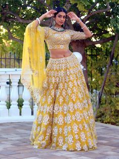 Go all out in this whimsical lehenga, studded with precious mirror, pearl, stone, embroidery work, which is sure to bring out the innate grace and grandeur in you! Color - Chrome Yellow Fabric & Work Style - - Silk blouse: mirror, pearl, stone, embroidery work. - Soft net lehenga: mirror, pearl, stone, embroidery work. - Soft net dupatta: embroidery work. Details - - Assured quality - Wash care instruction: Dry clean only. - Slight variation in color is possible due to digital photography. Navratri Hand Embellished Dupatta, Semi-stitched Hand Embellished Choli For Eid, Navratri Semi-stitched Hand Embellished Choli, Semi-stitched Hand Embellished Sets For Diwali, Hand Embellished Semi-stitched Choli For Eid, Navratri Hand Embellished Semi-stitched Choli, Eid Semi-stitched Hand Embellished Choli, Hand Embellished Semi-stitched Sets For Diwali, Traditional Draped Hand Embellished Lehenga For Navratri