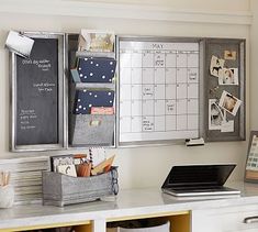 a white desk topped with lots of drawers and a chalkboard on the wall behind it