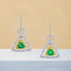 These earrings are gorgeous and stunning! Two trillion cut tsavorite garnets are set with round brilliant-cut diamonds and bright yellow sapphires. The garnets are a beautiful, brilliant grass-green color. The yellow sapphires and diamonds compliment and contrast with the green garnets and add even more sparkle. They are made of 18k white and yellow gold by our Master Jewelers in Los Angeles. Tsavorite garnets, 4.00 millimeters, .67 carat total118 round brilliant cut diamonds, .95 carat total36 round cut yellow sapphires, .18 carat total Luxury Green Diamond Earrings With Accents, Green Diamond Earrings Fine Jewelry, Green Diamond Earrings In Fine Jewelry Style, Green Pave Setting Fine Earrings, Green Brilliant-cut Earrings For May Birthstone, Green Brilliant Cut Earrings For May Birthstone, Green Gemstone Diamond Earrings, Green Brilliant Cut Drop Earrings, Green Diamond Earrings With Gemstone Accents