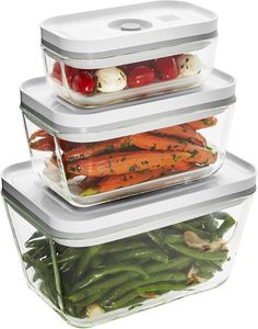 three plastic containers with food in them stacked on top of each other and filled with vegetables