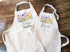 two personalized aprons with flowers on them