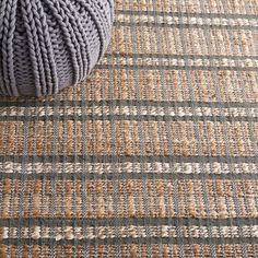 a ball of yarn sitting on top of a rug