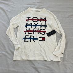 Tommy Hilfiger Long Sleeve Tee Size Medium (Boys) Condition: Nwt Color: White Details : - Graphic Tee Extra: - I Ship Between 1-2 Days Tommy Hilfiger Long Sleeve Cotton T-shirt, Tommy Hilfiger White Crew Neck Shirt, Tommy Hilfiger White Long Sleeve Tops, Tommy Hilfiger Letter Print Tops For Fall, Tommy Hilfiger White Graphic Print Top, Tommy Hilfiger Long Sleeve Casual T-shirt, Casual Long Sleeve T-shirt By Tommy Hilfiger, Casual Long Sleeve Tommy Hilfiger T-shirt, Tommy T Shirt