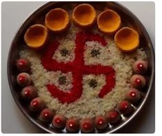 a metal plate topped with lots of food on top of a white tablecloth covered floor