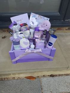 a purple box filled with lots of items on top of a cement floor next to a door