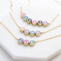 A stunning custom gold plated colourful enamel disc name necklace. PLEASE REFER TO PRODUCT IMAGE FOR PRE-SET INTITAL DISC COLOURS. This gorgeous personalised necklace features cute little enamel letter discs spelling out the name or word of your choice. The necklace will add a pop of colour and much JOY to any outfit. A wonderful gift for her for any occasion, and any age. Select the number of letters from the dropdown menu. Please note that initial colours are pre-set per initial, see images fo Colour Guide, Fine Necklace, Personalised Necklace, Faith Jewelry, Bridesmaid Pearls, Family Necklace, Necklace White, Initial Bracelet, Turquoise Stones