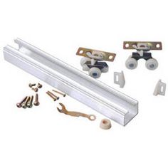 an assortment of hardware and parts for a sliding door with rollers, screws, and handles