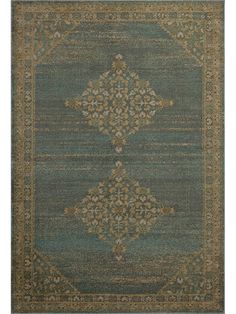 a blue rug with an ornate design on the front and back side, in various colors