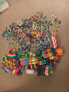 lots of beads and bracelets laid out on the floor