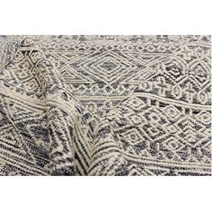 a white and black rug with an intricate design