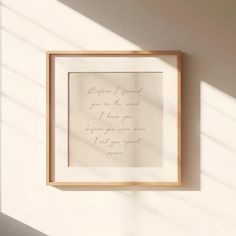 a wooden frame hanging on the wall with a handwritten quote