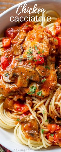 chicken cacciatore with pasta in a white bowl