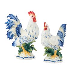 two ceramic rooster figurines sitting side by side on top of each other in blue and white