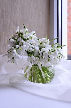 a vase filled with white flowers on top of a table