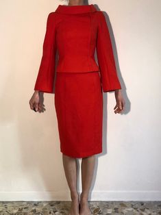 Wow! Amazing Thierry Mugler red wool jacket and skirt set. As always these Mugler pieces have been made impeccably - such craftsmanship! Mugler is always sewn and patterned with the most care. Love this amazing saturated intense red. The fabric is a fine wool suiting. The fabulous Mugler style can be seen with the great folded over boat neck collar and asymmetrical front closure. Hidden metal silver snaps up the asymmetrical closure. Raglan sleeve with trumpet shape. Crisp curved shoulder - no s Elegant Red Formal Skirt Suit, Red Long-sleeve Skirt Suit For Office, Tailored Red Skirt Suit For Office, Red Long-sleeve Skirt Suit For Party, Red Long Sleeve Skirt Suit For Work, Fall Formal Red Skirt Suit, Elegant Red Skirt Suit For Work, Red Fitted Skirt Suit For Party, Red Long Sleeve Skirt Suit For Party