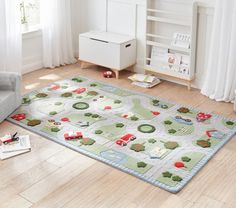 a child's rug with cars and trucks on it in a living room area