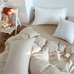 a bed that has some pillows on it