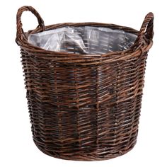 a brown wicker basket filled with plastic wrap and some silver foil in the bottom