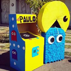 two cardboard boxes that have faces and eyes on them, one is yellow and the other is blue