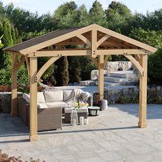 an outdoor living area with couches, tables and a pergolated gazebo