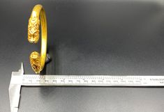 A Beautiful Old Bracelet Of Gold At The Two Ends Decorated With Tiger Head Figures Symbolize Might Strength. Worn For Protection And Prosperity. Good Patina On The Surface And Certification Of Gold available On Request Of Customer. We Test Gold Already Its 18 Karat Gold. Size Details Pictures Are Listed Above. Gold Byzantine Carved Jewelry, Byzantine Style Carved Gold Jewelry, Luxury Gold Cuff Bracelet For Ceremonial Use, Luxury Gold Cuff Bracelet For Ceremonial Occasions, Gold Carved Bracelets For Ceremonial Occasions, Luxury Carved Gold Jewelry, Luxury Gold Brass Bangle, Ceremonial Gold Engraved Bangle, Antique Gold Bracelets For Rituals