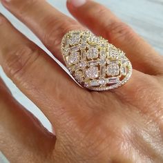 a woman's hand with a large diamond ring on it