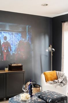 a living room filled with furniture and a flat screen tv mounted to the side of a wall