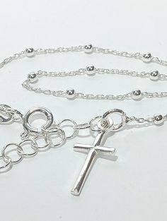 Rosary bracelet with cross in 925 sterling silver. -Classic Model -Casual design -Ideal for a gift -With gift envelope -symbol of being in grace with God when the bracelet comes with ten beads symbolizing to pray the rosary. Also the Christian cross. - Measures 17 cm long plus 3 cm extension. Silver Cross Bracelets For Gifts, Minimalist Sterling Silver Cross Bracelet, Dainty Sterling Silver Cross Bracelet, Silver Cross Bracelet, Spiritual Style, Nickel Free Silver Cross Bracelets, Nickel-free Cross Bracelet Gift, Silver Bracelet With Cross Pendant As Gift, Nickel Free Sterling Silver Cross Bracelets, Nickel-free Silver Cross Bracelets