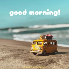 a yellow van parked on top of a sandy beach