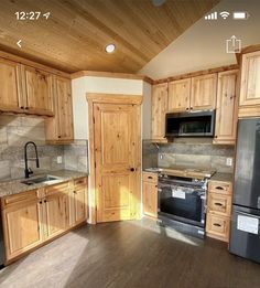 a kitchen with wooden cabinets and black appliances