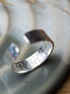 .925 Sterling silver adjustable ring.  A chunkier version of our rings for men (or women of course) with hammered effect  6mm x 1.5 mm Each letter is individually hand stamped by myself, with your own names, dates or choice of words. (up to 20 characters per line) A heart or star can be added by simply adding an emoji or (Heart) (Star) where you would like it placed.  For example  (Star) we love you daddy  Elsie and Charlie  Adjustable size, so one size fits all.  To adjust gently pull or push to create the desired size.  Presented in an eco friendly  'Raspberry Ripple' gift box. Mens Happy Birthday, Raspberry Ripple, Hammered Band, Secret Messages, Lovely Ring, Open Ring, Adjustable Ring, Engagement Gifts, Adjustable Rings