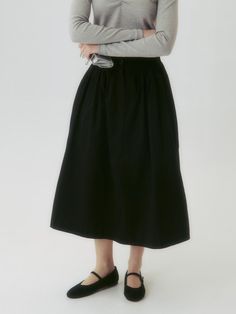 This product is a Button Flared Skirt, designed with a graceful flared silhouette that adds a touch of elegance and movement to the overall look. Its high-waist style accentuates the waistline, while the button details provide a classic and refined touch. This versatile skirt is suitable for both formal and casual settings, offering endless styling possibilities. - The skirt features a flared design that creates a sophisticated and feminine silhouette.- A series of buttons along the front add a vintage charm and visual interest.- Made from a smooth fabric, the skirt ensures comfort and a fluid drape.- Its versatile style pairs well with both fitted tops for a polished look and casual tees for a more relaxed outfit. Chic Long Skirt With Button Closure, Black Voluminous Skirt For Daywear, Button Closure Maxi Skirt For Work, Workwear Long Skirt With Button Closure, Long Skirt With Button Closure For Work, Long Skirt Bottoms With Button Closure For Workwear, Elegant Relaxed Maxi Skirt With Button Closure, Chic Flared Skirt Bottoms With Button Closure, Black Full Skirt Bottoms For Daywear