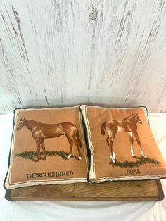 two pillows that have horses on them