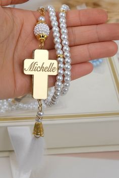 "Show your gratitude to your baptism guests with these personalized rosary favors. They are made with different colors and comes in sachet. The cross have the name and date of the baptism for a personal touch. Our rosaries are suitable for any religious occasion, such as baptism, christening, bautizo, first communion or confirmation. -This is a lovely souvenir that features glass pearl rosary beads with the baby's name and baptism date on a cross. It is a token of your special day that the baby Personalized Cross Rosary Bracelet For Baptism, Personalized Spiritual Rosary Gift, White Spiritual Rosary For Mother's Day, Mother's Day White Spiritual Rosary, Spiritual White Rosary For Mother's Day, White Rosary For Mother's Day Gift, Customizable White Rosary Bracelet As A Gift, Customizable White Rosary Bracelet As Gift, Customizable White Rosary Bracelet Gift