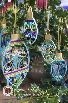 some ornaments hanging from a tree with green leaves