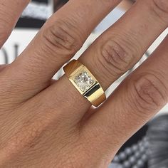 a woman's hand with a ring on it and a diamond in the middle