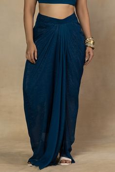 Teal blue asymmetric cape featuring mirror and resham embroidery on the neckline. Paired with a solid crop top and a draped skirt. - Aza Fashions Elegant Festive Georgette Skirt, Party Wear Pre-draped Maxi Saree, Party Maxi-length Pre-draped Saree, Party Maxi Length Pre-draped Saree, Elegant Saree Skirt For Party, Elegant Maxi-length Pre-draped Saree, Elegant Maxi Length Pre-draped Saree, Elegant Georgette Skirt With Traditional Drape, Bohemian Pre-draped Saree With Sheer Dupatta For Party