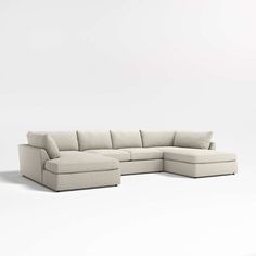 a white sectional couch sitting on top of a white floor