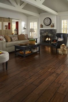 a living room filled with furniture and a fire place in the middle of the room