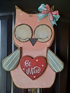 a wooden sign with an owl holding a heart on it's chest that says be mine